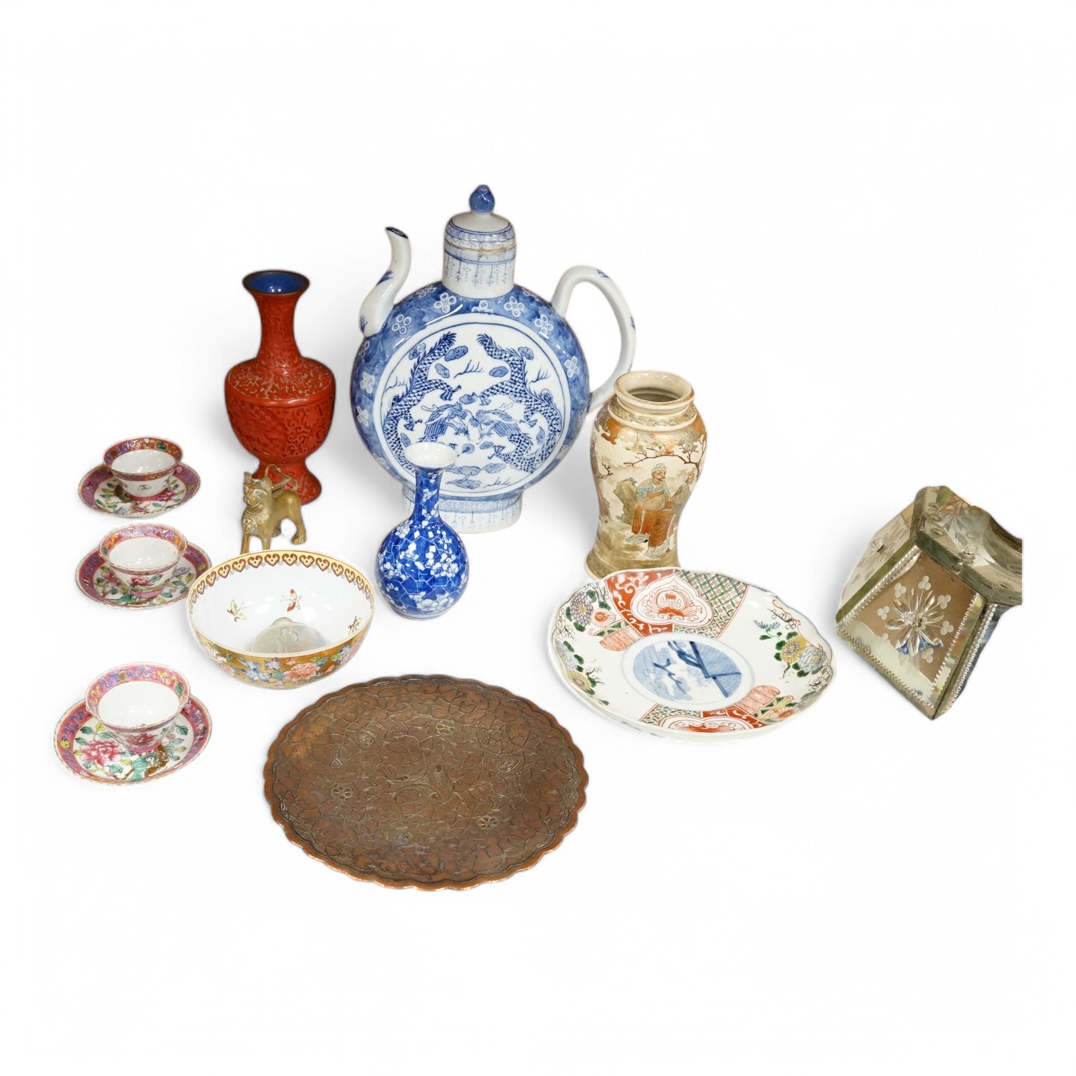 A group of mixed oriental porcelain and metalware to include a Japanese satsuma vase, cinnabar lacquer vase and blue and white teapot, largest 32cm high.